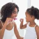 Mother Teaching Daughter To Brush Teeth | Burt's Pharmacy and Compounding Lab