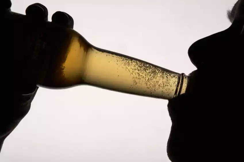 Silhouette man drinking beer | Burt's Pharmacy and Compounding Lab