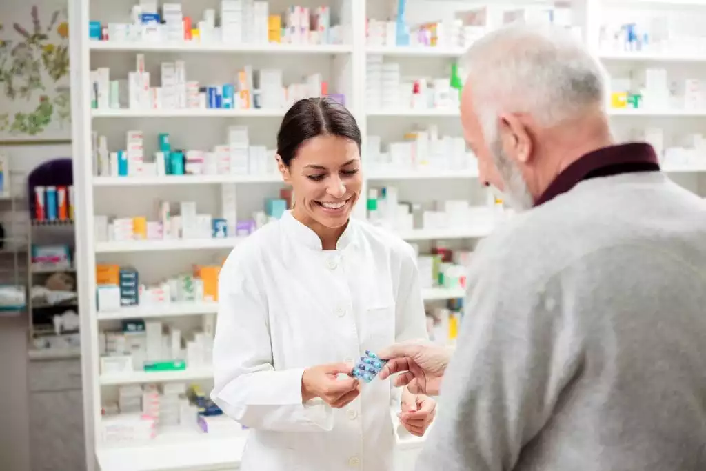 Pharmacist Helping Customer - Burt's Pharmacy and Compounding Lab